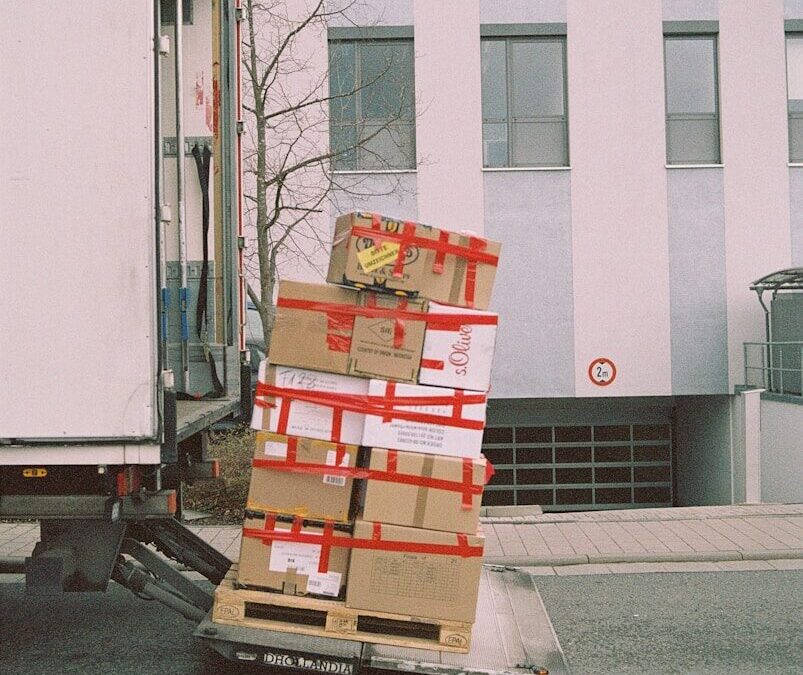 brown cardboard boxes on gray asphalt road